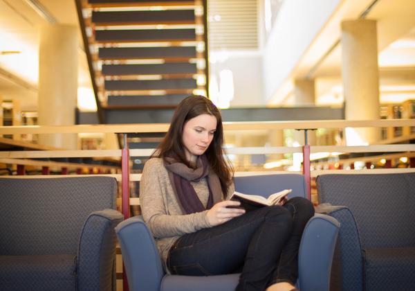 A Bachelor of Arts in English Honours, Major, Minor student studying for her writing courses in the library